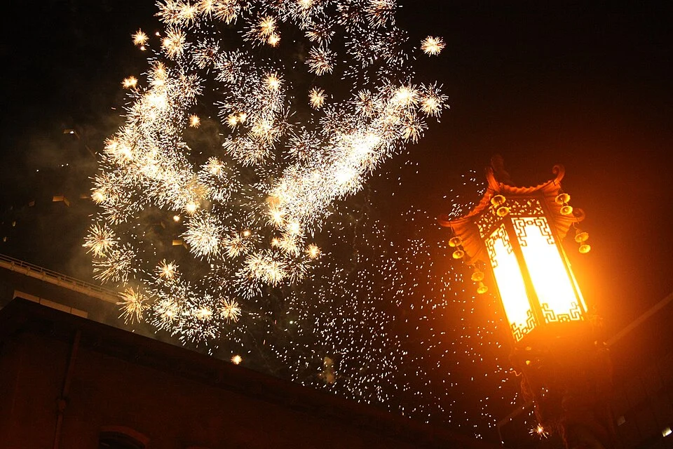 Golden Fourth of July fireworks above a lantern in San Francisco’s Chinatown